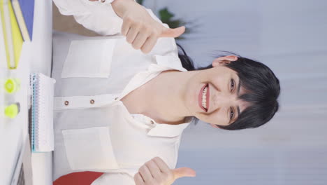 Vertical-video-of-Female-student-looking-at-camera-with-positive-and-positive-gesture.